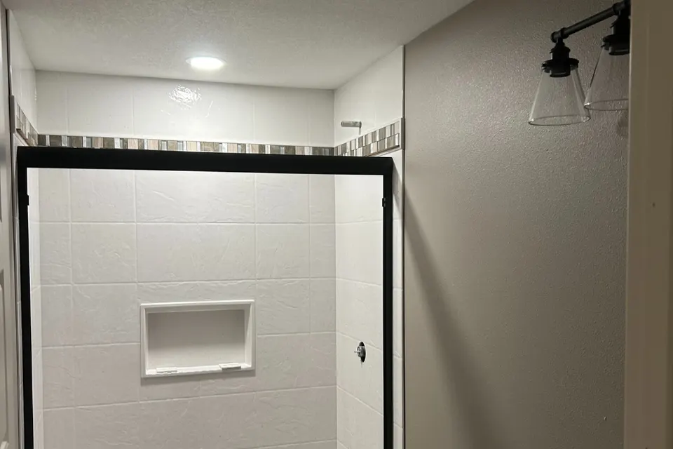 Basement bathroom with a recessed light, exhaust fan, and two-light vanity fixture