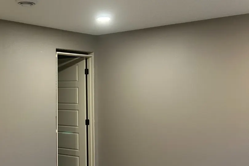 Newly finished basement bedroom with a recessed ceiling light